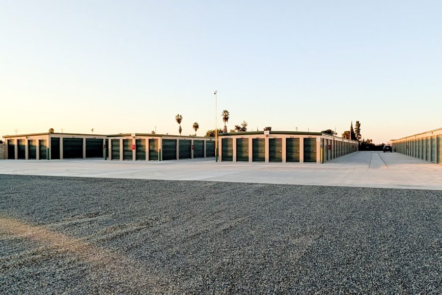 Exterior view of Wasco Mini Storage facility with multiple buildings and palm trees
